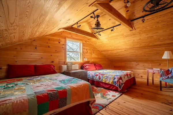 a bedroom with two beds and a chandelier