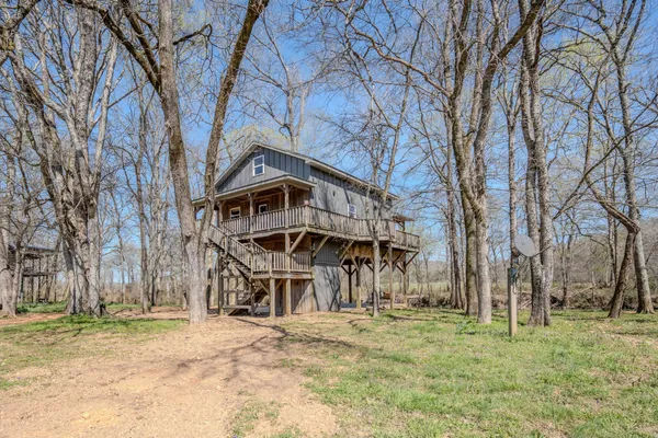 a view of a house with large trees