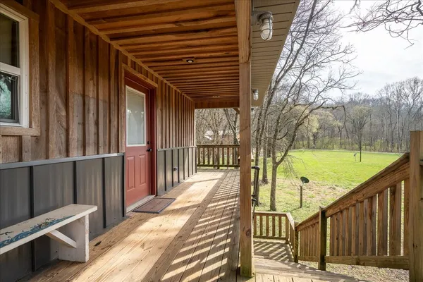 a view of balcony with wooden floor and fence