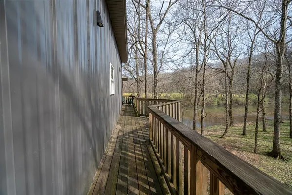 a view of balcony with wooden floor and fence