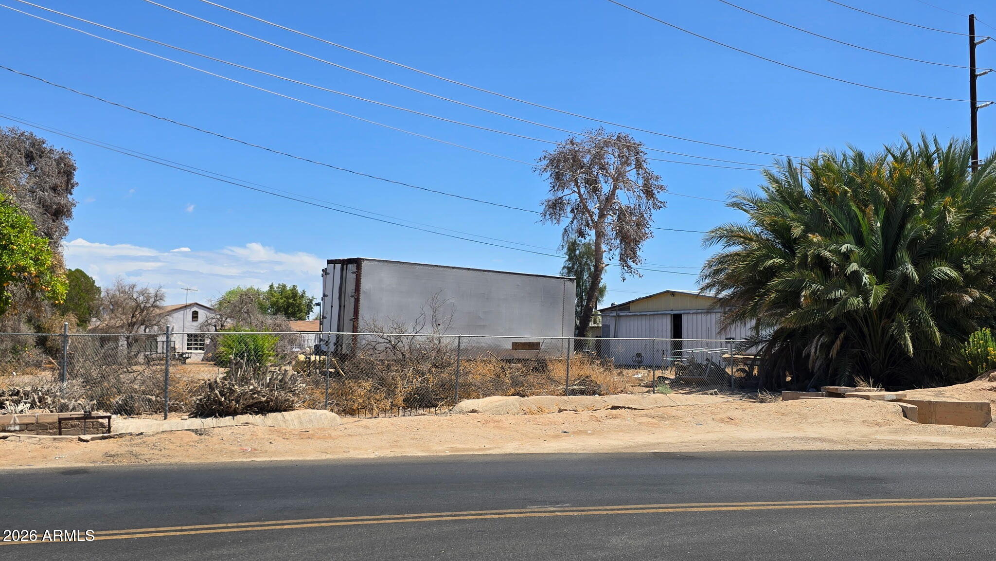 6803 South Miller Road Buckeye, AZ 85326 - Photo 40 of 50 a view of a house with a yard and a garage