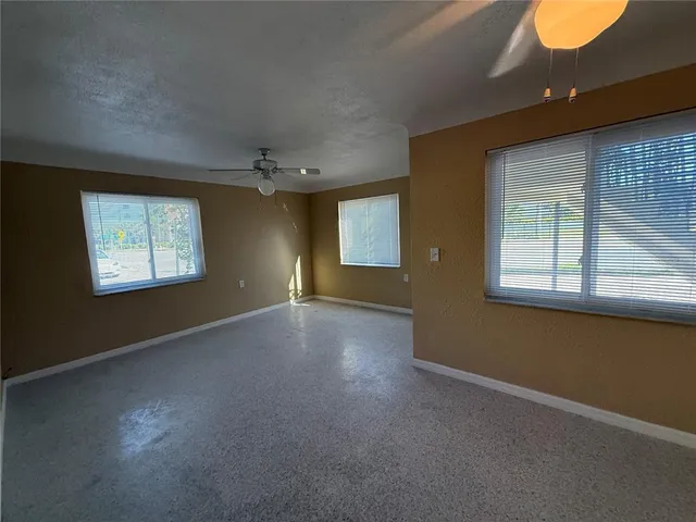 a view of a livingroom with a ceiling fan and window