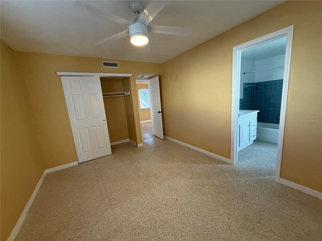 17688 Gulf Boulevard, Unit 104 Redington Shores, FL 33708 - Photo 8 of 15 an empty room with closet and a ceiling fan