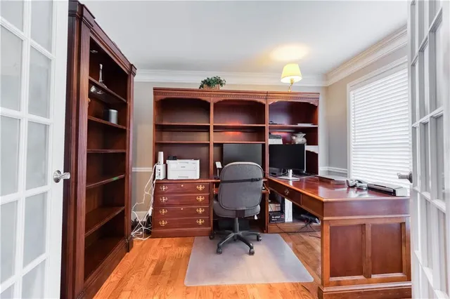 a spacious bedroom with a bed a couch and a flat screen tv