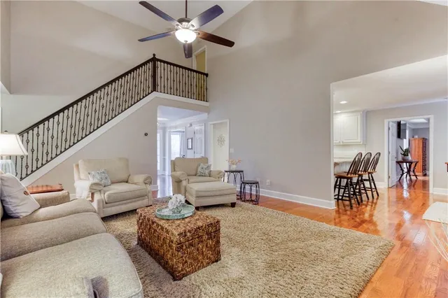 an empty room with wooden floor a ceiling fan and closet