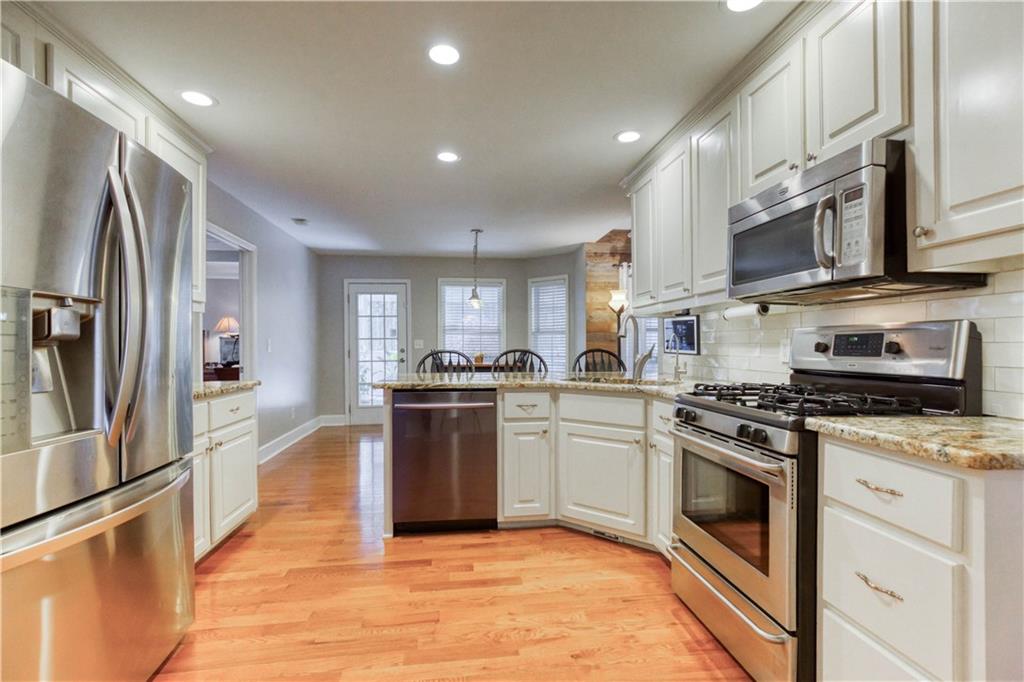 2521 Culpepper Trail Southeast Bethlehem, GA 30620 - Photo 31 of 83 a kitchen with stainless steel appliances granite countertop a stove a sink and a refrigerator