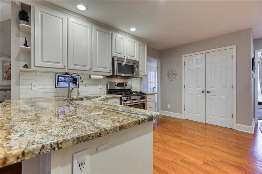 2521 Culpepper Trail Southeast Bethlehem, GA 30620 - Photo 33 of 83 a kitchen with stainless steel appliances granite countertop a stove a sink and a microwave