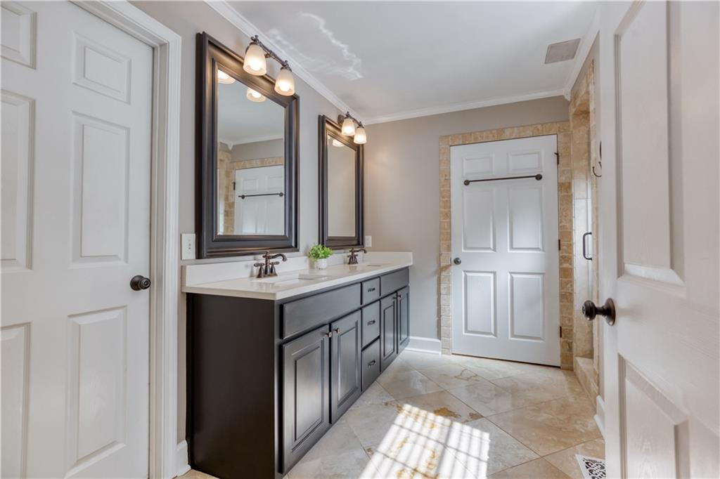 2521 Culpepper Trail Southeast Bethlehem, GA 30620 - Photo 43 of 83 a bathroom with a double vanity sink and mirror