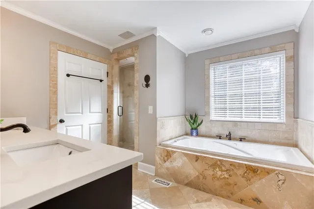 a front view of a house with barbeque oven and seating space