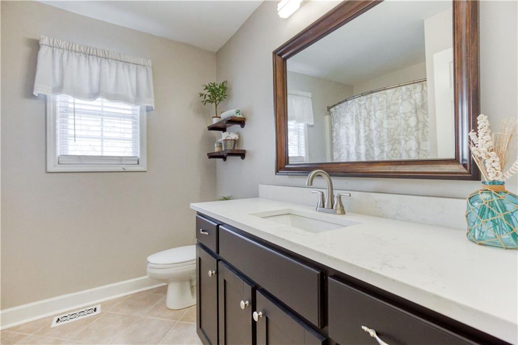2521 Culpepper Trail Southeast Bethlehem, GA 30620 - Photo 50 of 83 a bathroom with a granite countertop sink a toilet and a window
