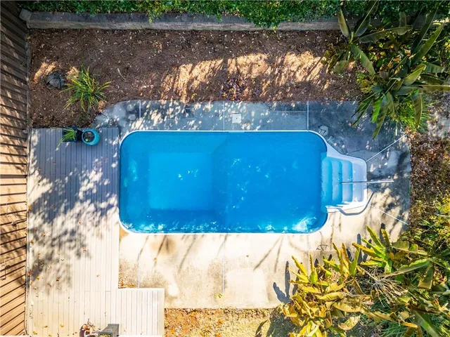 a view of a brick house with large windows