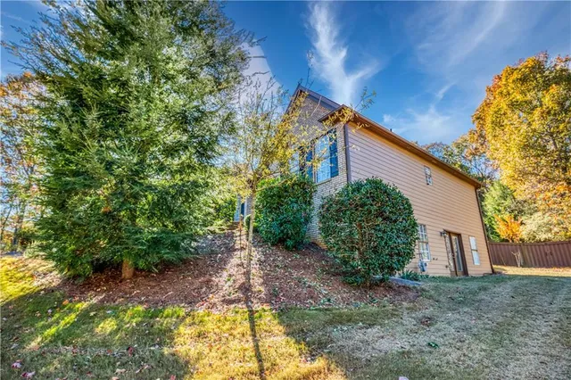 a view of a livingroom with furniture wooden floor and kitchen view