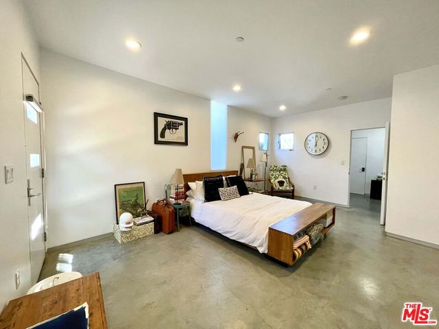 a bed room with a bed and a chair