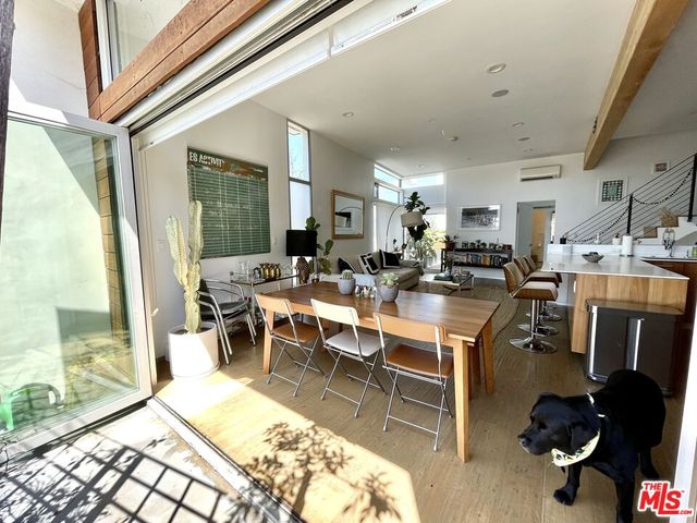 a living room with lots of furniture and a view of kitchen