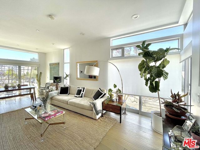 a living room with furniture rug and wooden floor