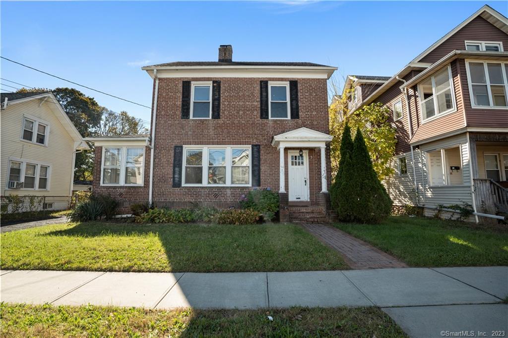 a front view of a house with a yard
