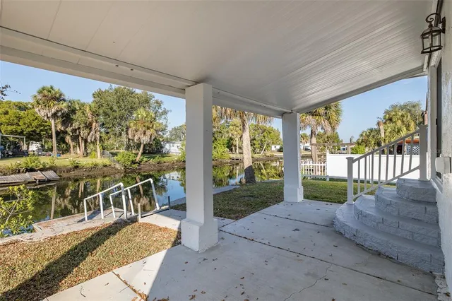 a view of a kitchen with wooden floor and a window