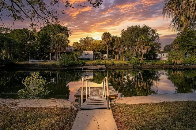 a kitchen with granite countertop a refrigerator and a stove top oven