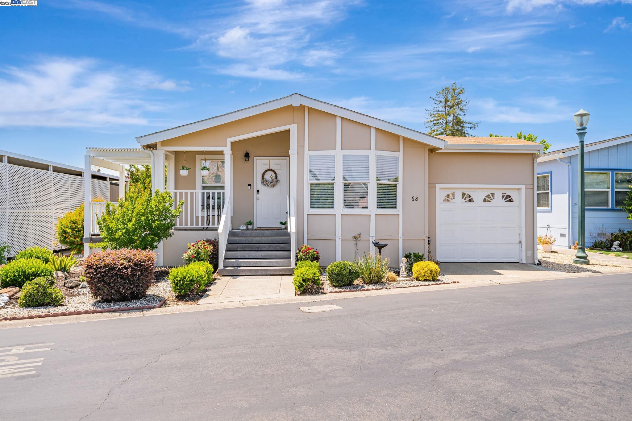 3263 Vineyard, Unit 68 Pleasanton, CA 94566 - Photo 2 of 41 a view of a house with a yard and potted plants