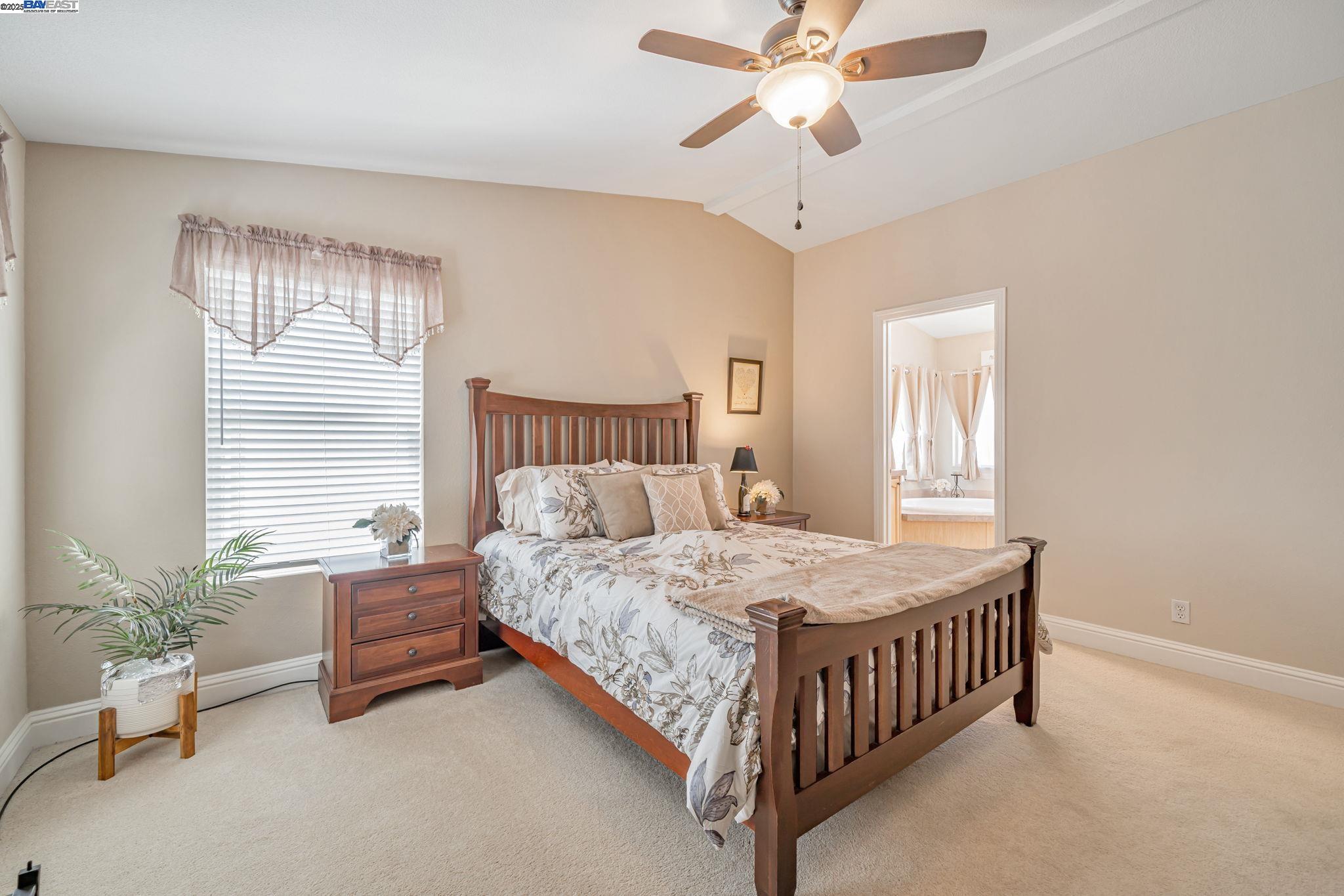 3263 Vineyard, Unit 68 Pleasanton, CA 94566 - Photo 28 of 41 a bedroom with a bed chandelier and a window