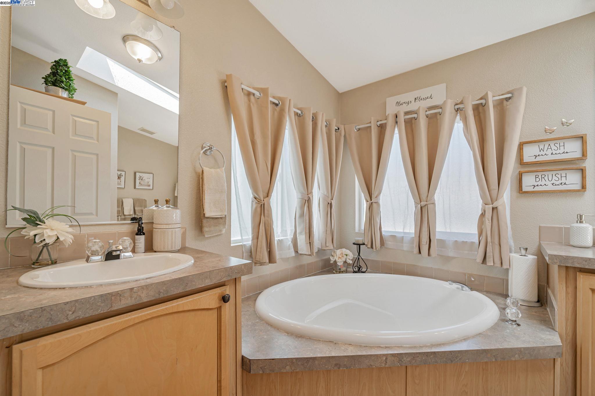 3263 Vineyard, Unit 68 Pleasanton, CA 94566 - Photo 30 of 41 a bathroom with a double vanity sink and a mirror