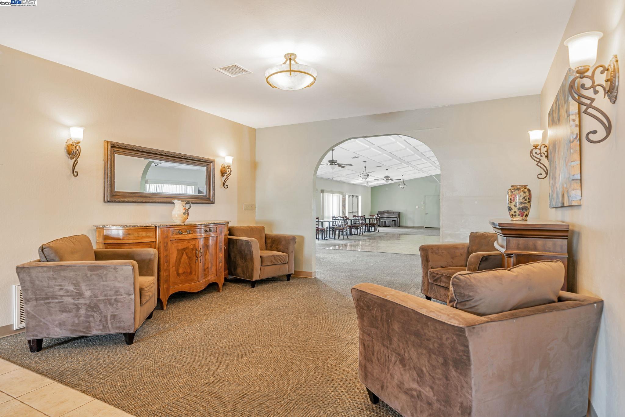 3263 Vineyard, Unit 68 Pleasanton, CA 94566 - Photo 34 of 41 a living room with furniture and a large mirror