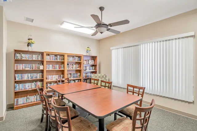 a room with pool table and windows