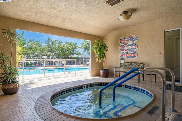 a view of swimming pool and trees in the background