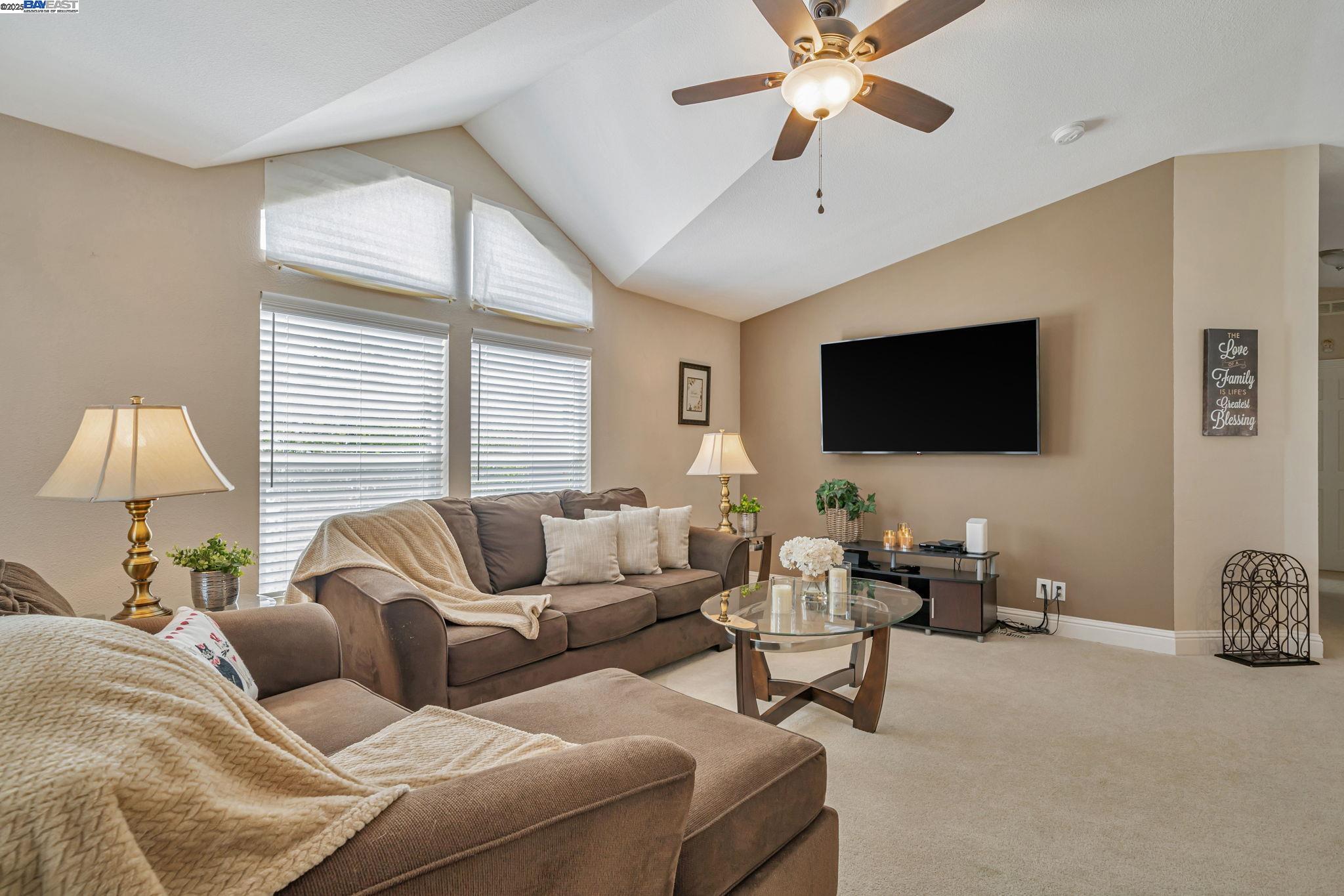 3263 Vineyard, Unit 68 Pleasanton, CA 94566 - Photo 4 of 41 a living room with furniture and a flat screen tv