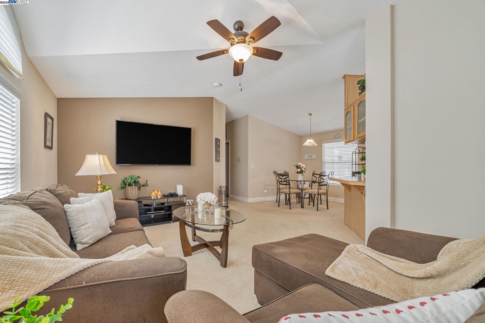 3263 Vineyard, Unit 68 Pleasanton, CA 94566 - Photo 6 of 41 a living room with furniture and a flat screen tv