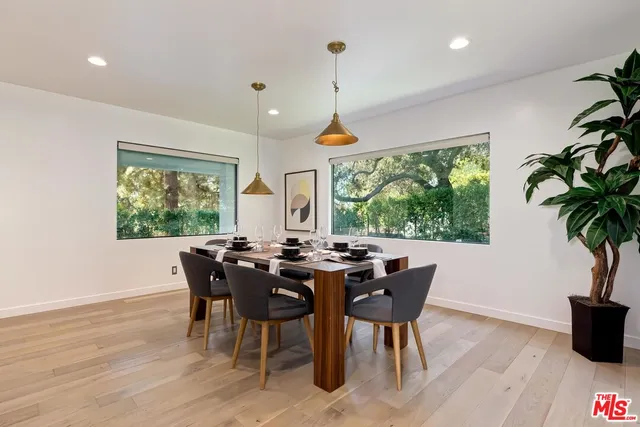 a view of a dining room with furniture window and wooden floor