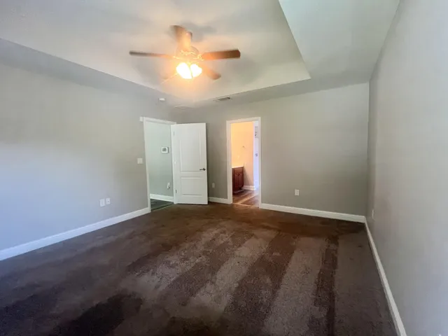 a spacious bathroom with a double vanity sink a large mirror and shower
