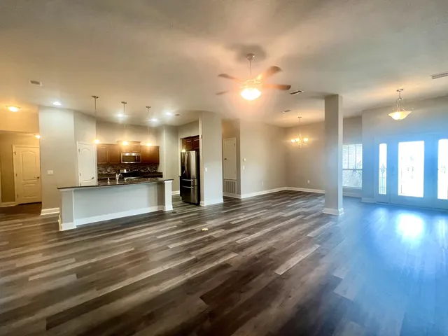 a kitchen with stainless steel appliances granite countertop a refrigerator and a stove