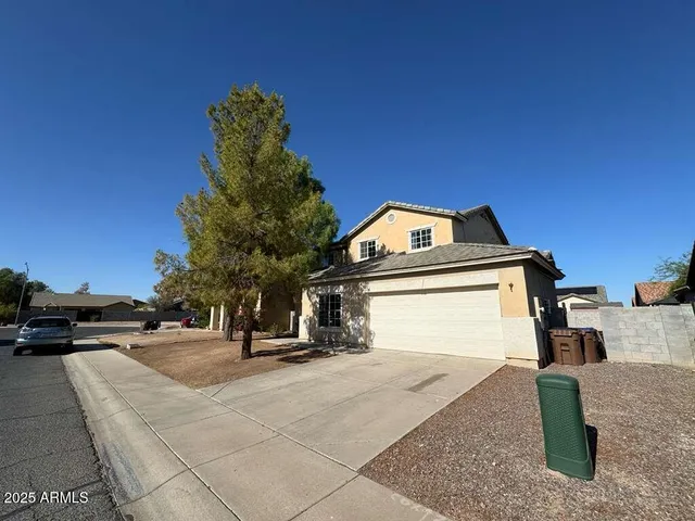 a view of a house with a sink and parked cars
