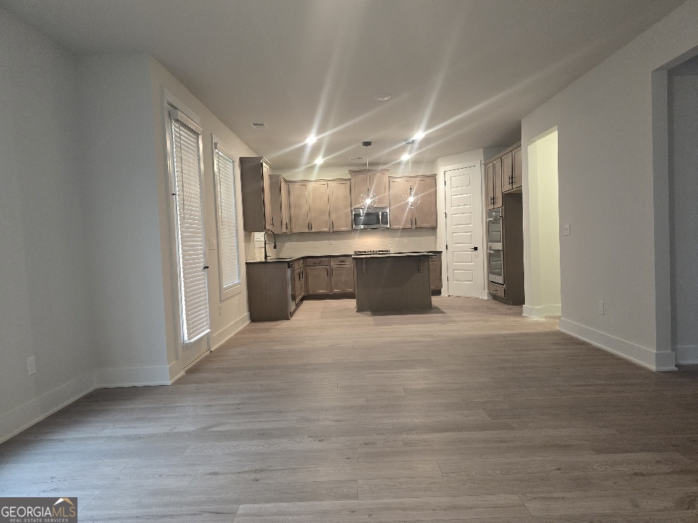 128 Patillo Manor, Unit 7 Stockbridge, GA 30281 - Photo 13 of 37 a open kitchen with stainless steel appliances granite countertop a refrigerator and a sink