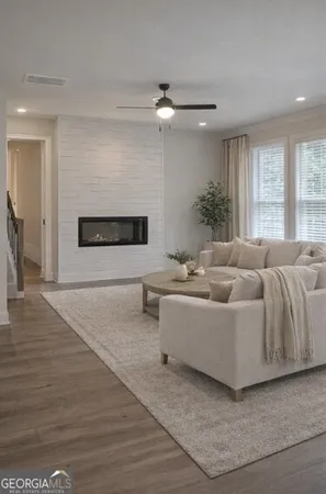 a view of an empty room with a fireplace and a window