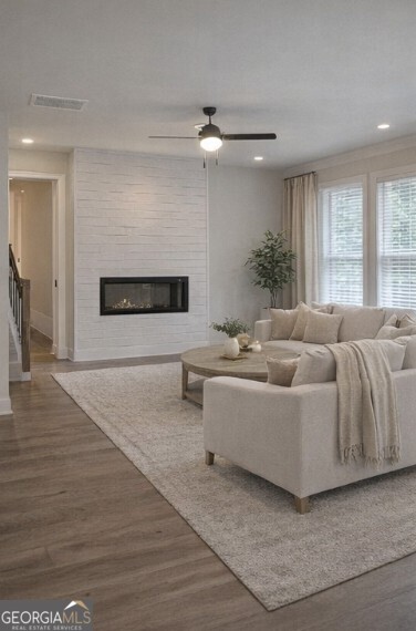 128 Patillo Manor, Unit 7 Stockbridge, GA 30281 - Photo 14 of 37 a living room with furniture and a fireplace