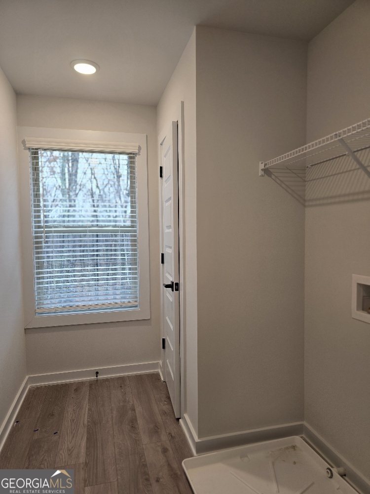 128 Patillo Manor, Unit 7 Stockbridge, GA 30281 - Photo 16 of 37 a view of an empty room with wooden floor and a window