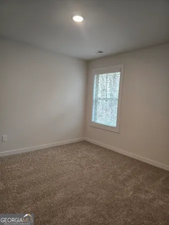 a view of a dining room with furniture and window