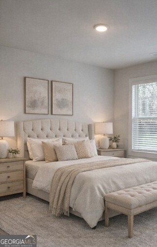 128 Patillo Manor, Unit 7 Stockbridge, GA 30281 - Photo 23 of 37 a bedroom with a bed and a couch