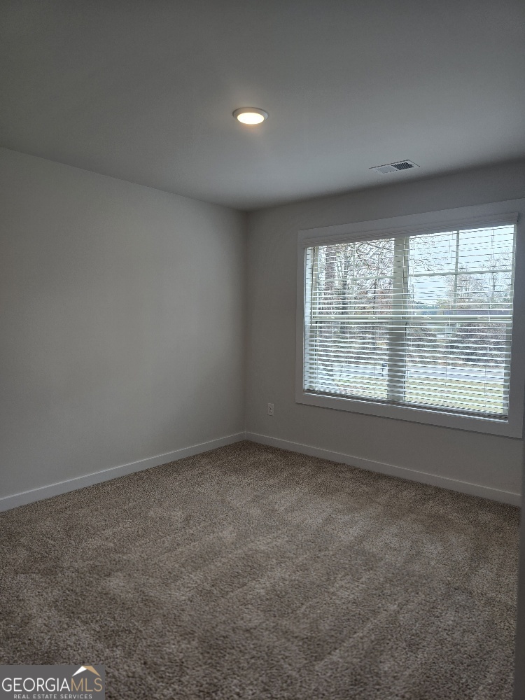 128 Patillo Manor, Unit 7 Stockbridge, GA 30281 - Photo 25 of 37 an empty room with windows