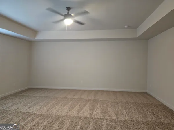 an empty room with a empty space and a ceiling fan