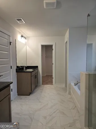 a bathroom with a bath tub and shower
