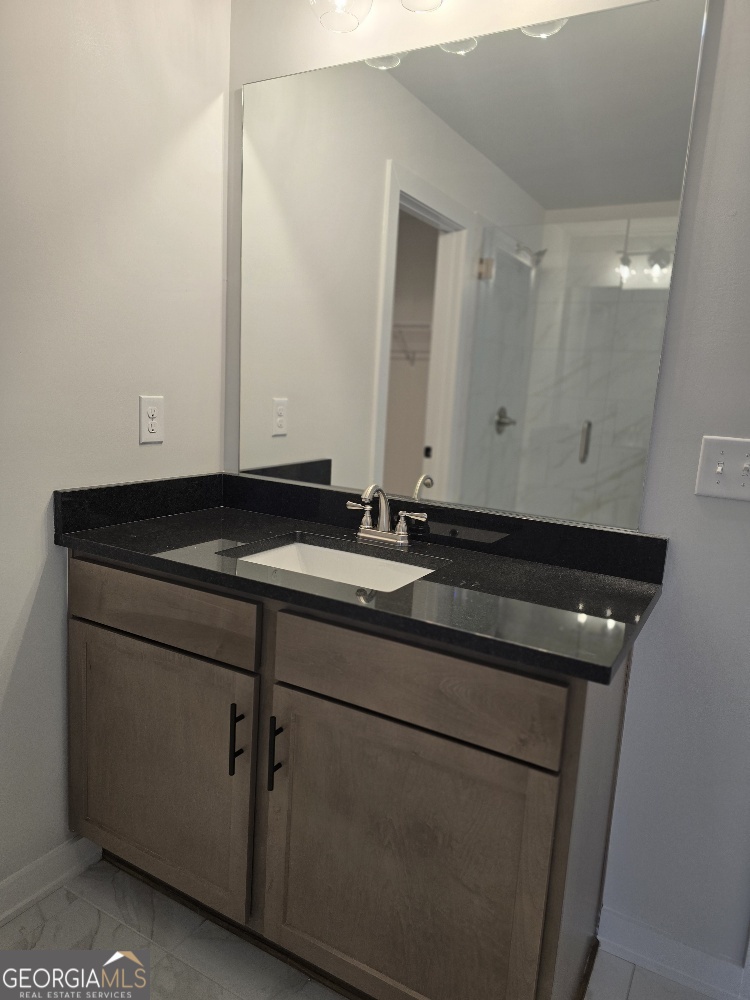 128 Patillo Manor, Unit 7 Stockbridge, GA 30281 - Photo 34 of 37 a bathroom with a sink and a mirror