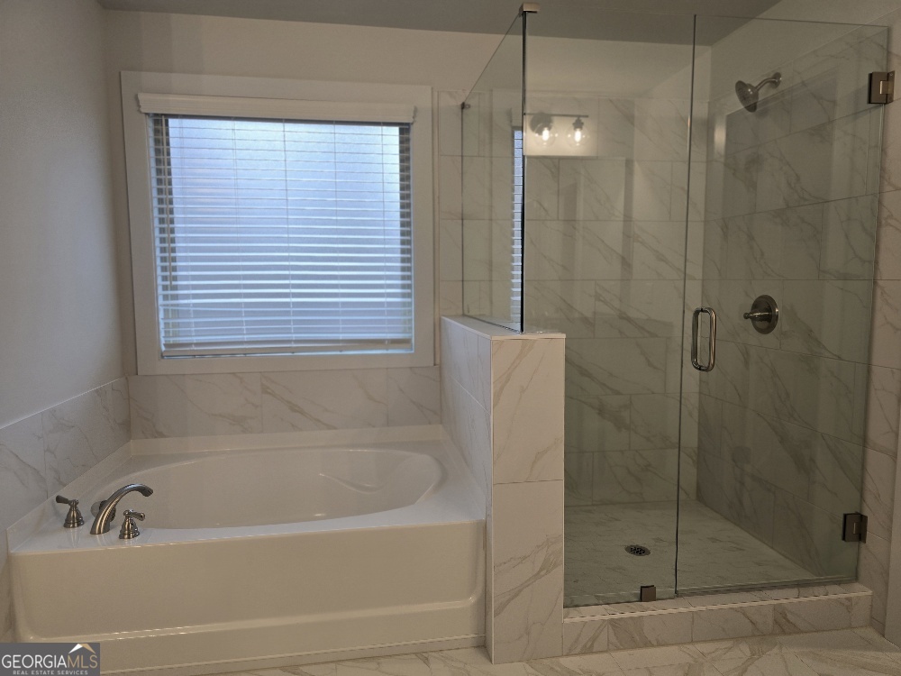 128 Patillo Manor, Unit 7 Stockbridge, GA 30281 - Photo 35 of 37 a bathroom with a bath tub and shower