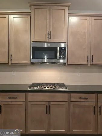 a kitchen with a sink stove and microwave