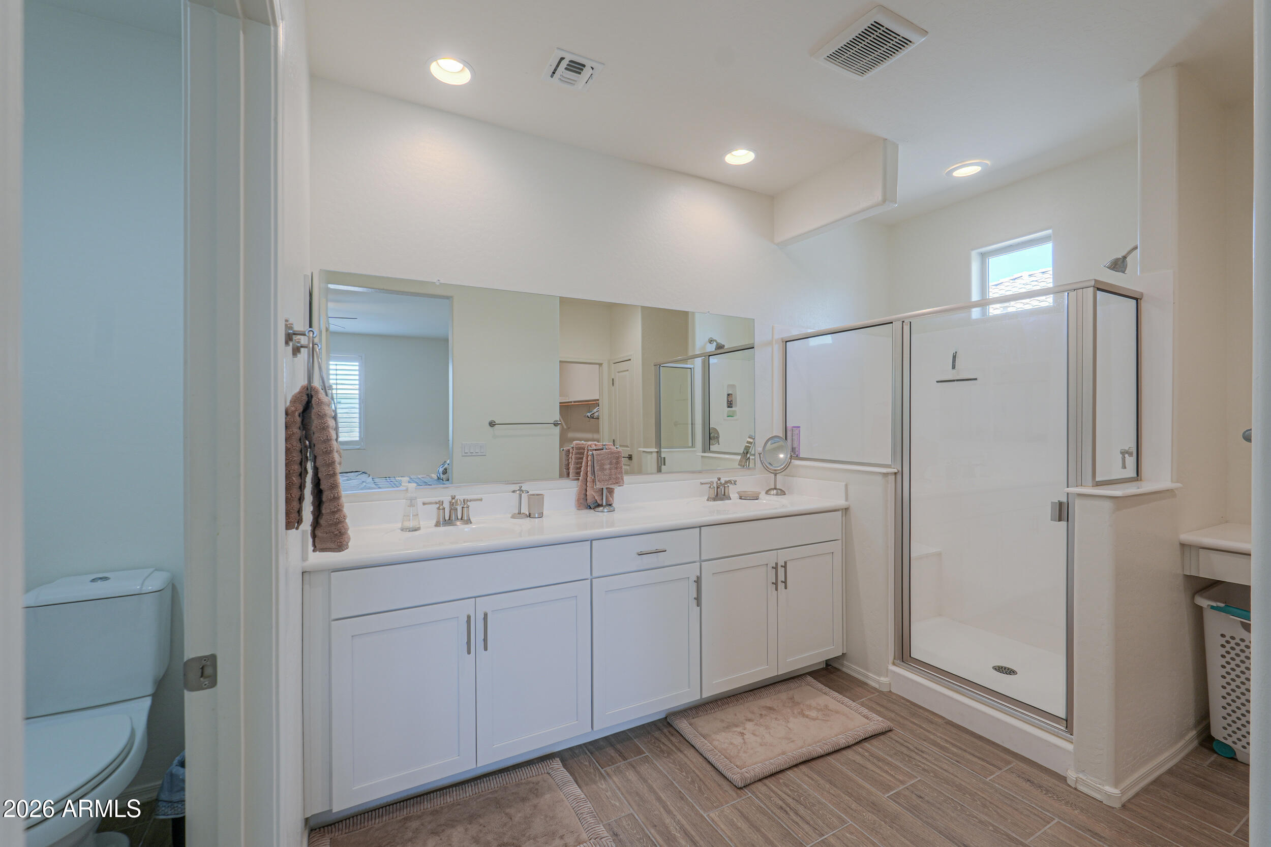 42085 West Cribbage Road Maricopa, AZ 85138 - Photo 24 of 35 a bathroom with a double vanity sink and mirror