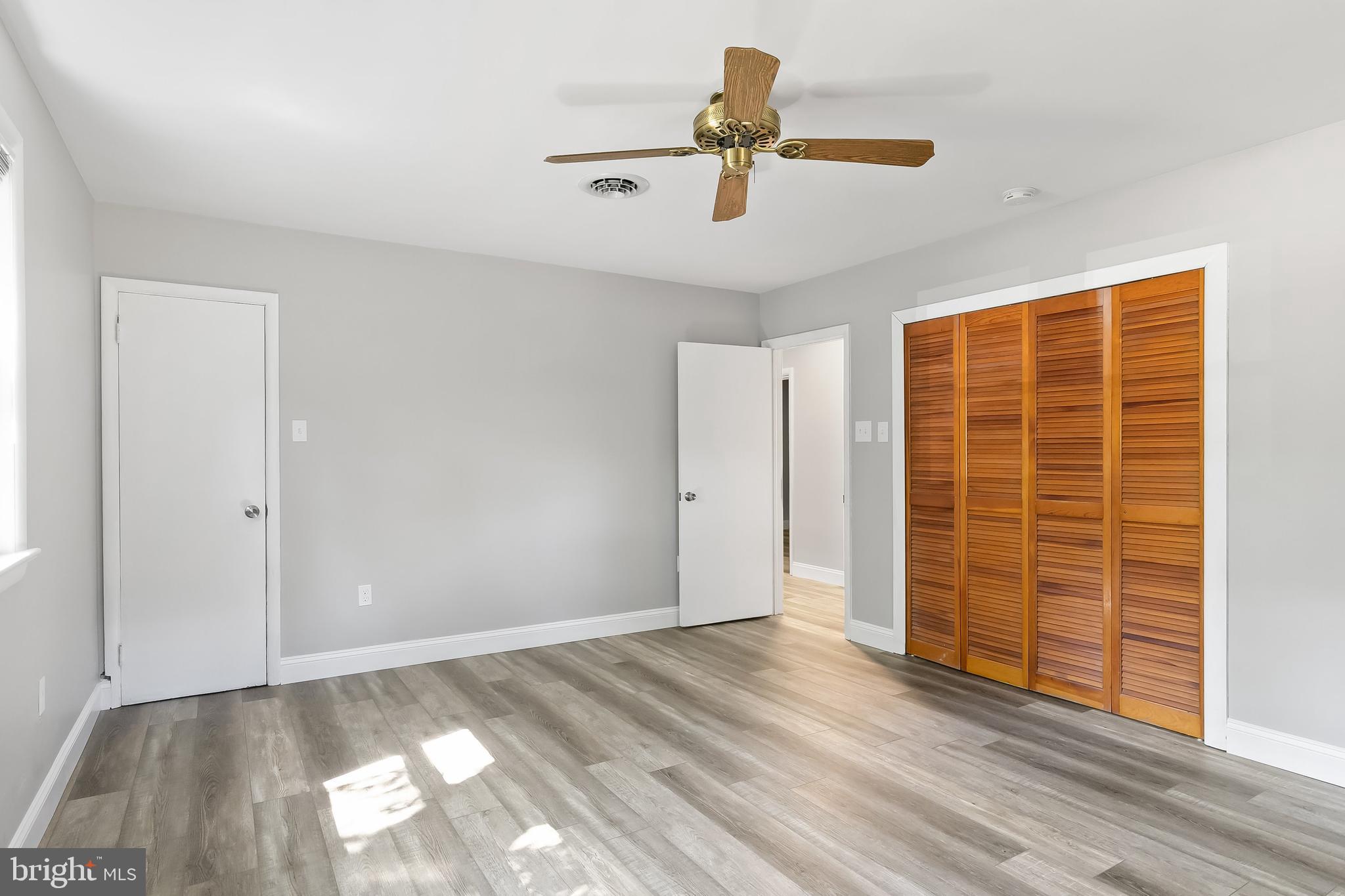 405 Hamilton Road Glassboro, NJ 08028 - Photo 18 of 28 a view of empty room with wooden floor and fan