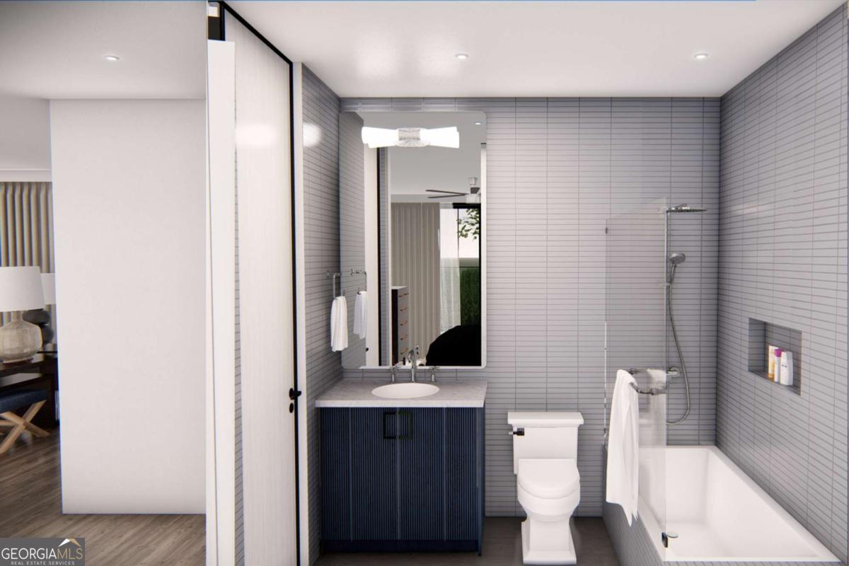1554 South Lumpkin Street, Unit 5 Athens, GA 30605 - Photo 22 of 24 a bathroom with a toilet a sink and mirror