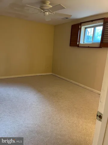 an empty room with windows and painted walls